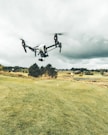 turned on white and black quadcopter drone