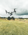 turned on white and black quadcopter drone
