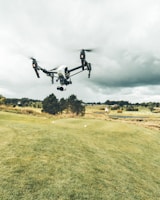 turned on white and black quadcopter drone