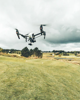 turned on white and black quadcopter drone