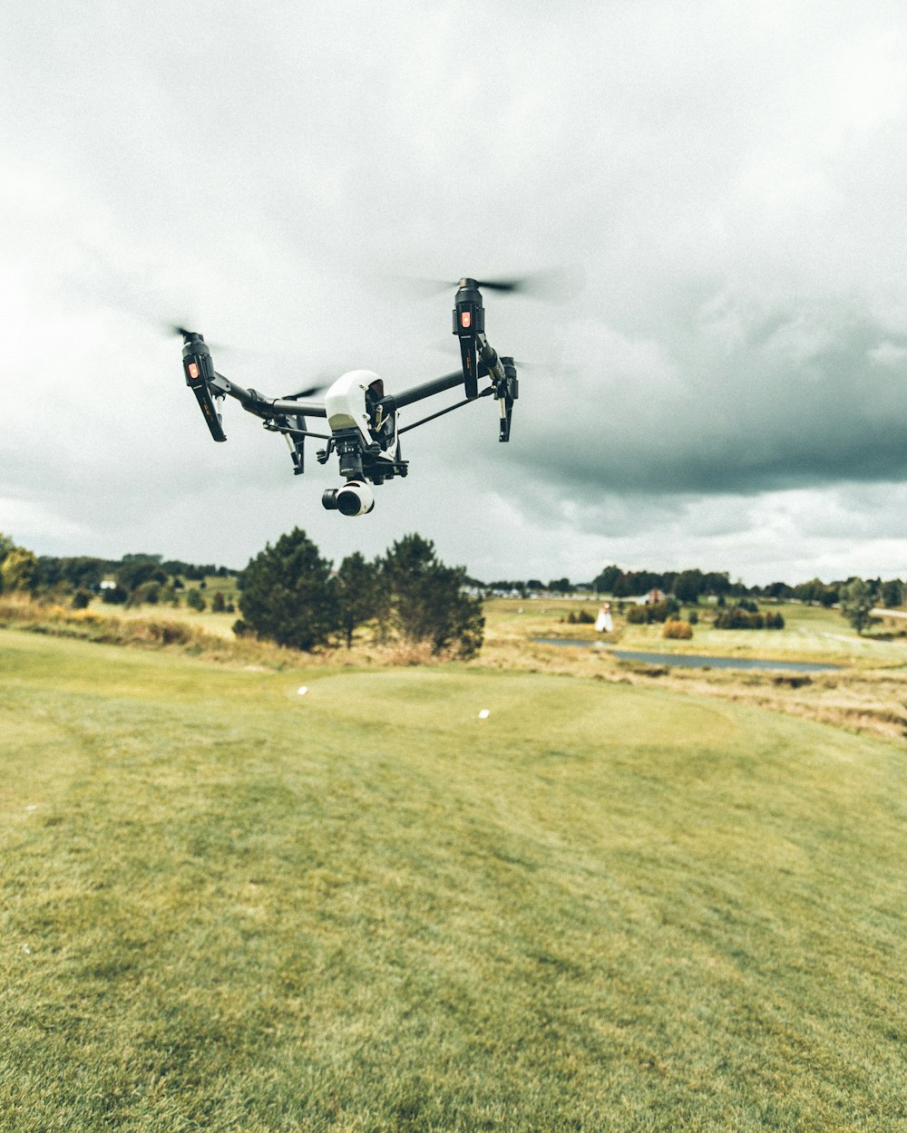 turned on white and black quadcopter drone