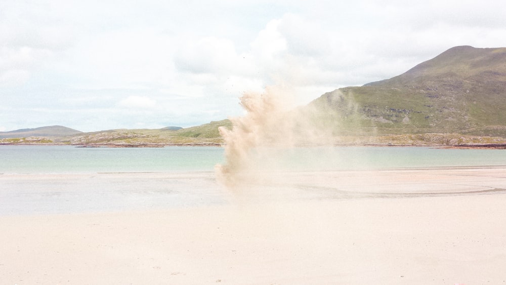 white sand near body of water during daytime