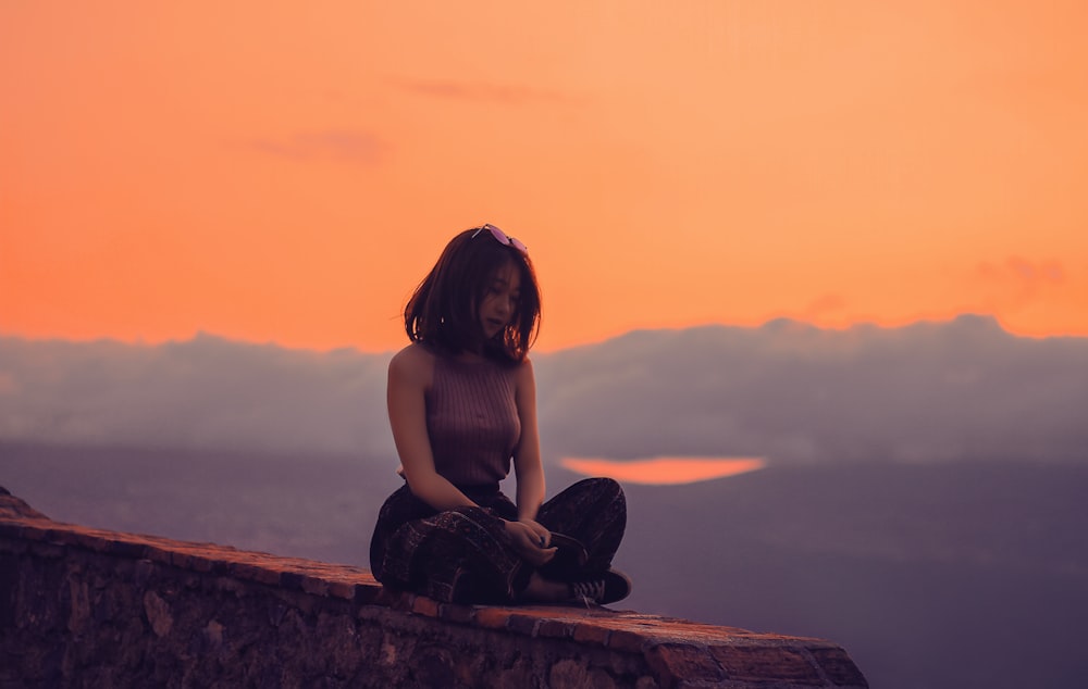 woman sitting on a cliff