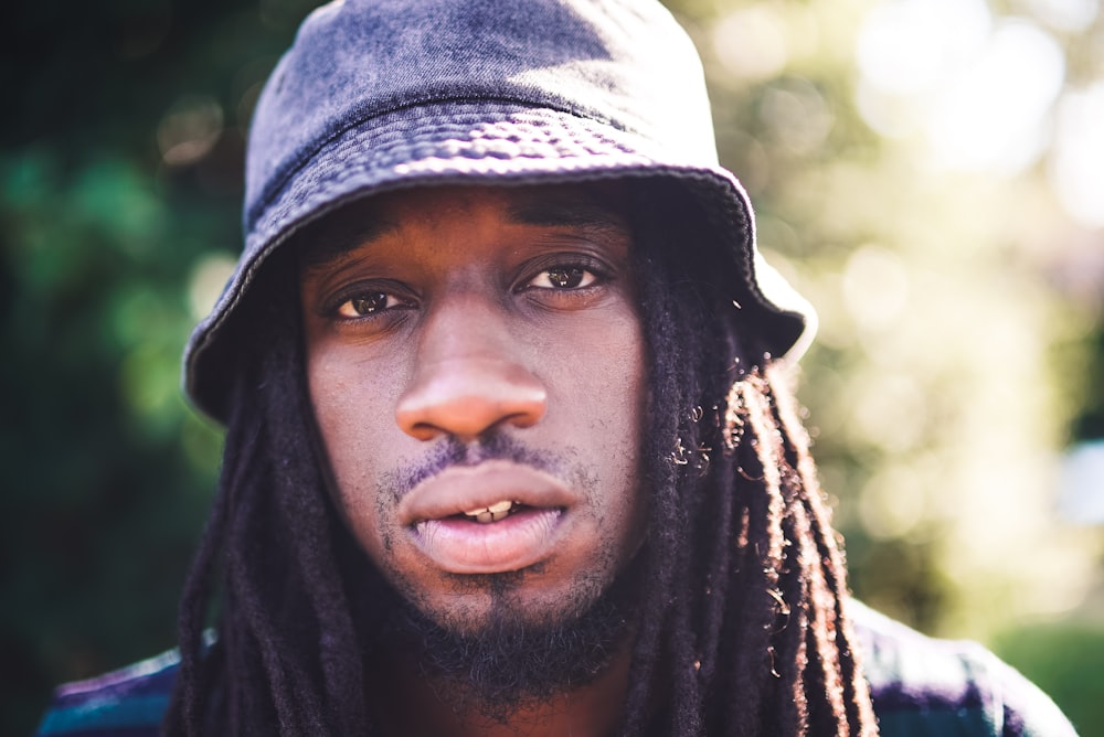 portrait photography of man with dreadlocks