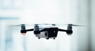 black quadcopter drone selective focus photograph