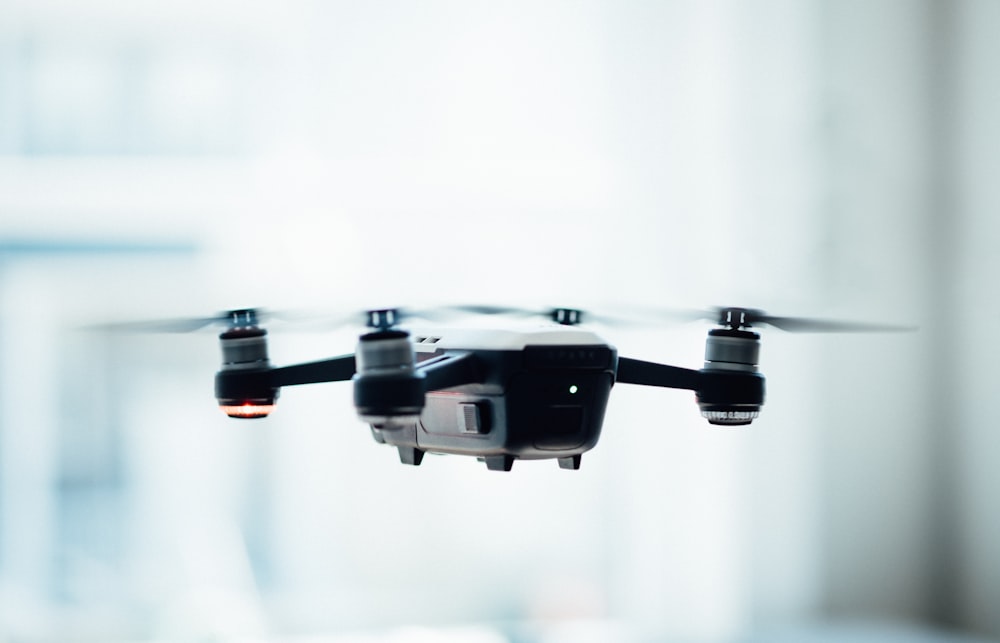 black quadcopter drone selective focus photograph