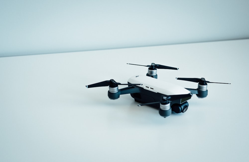 white and black quad copter drone
