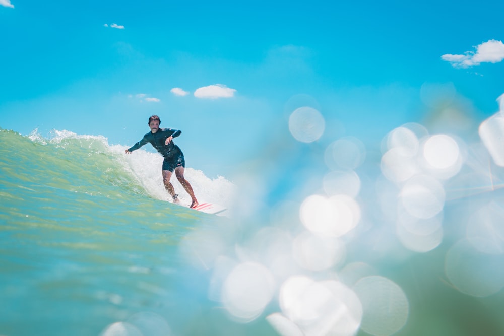 person surfing on wave during daytime