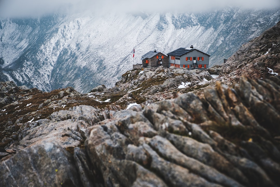 house on black mountain covered by snow