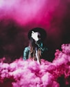 person standing around pink smokes