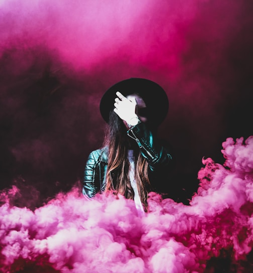 person standing around pink smokes