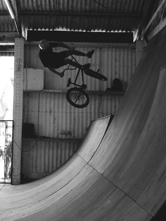 grayscale photography of man riding bike in Rosario Argentina