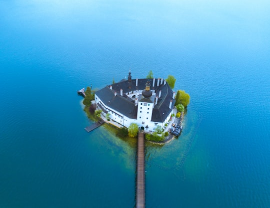 aerial photo of white and blue building on island in Gmunden Austria