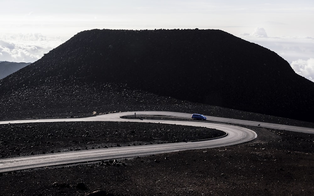 blue car driving on asphalt road