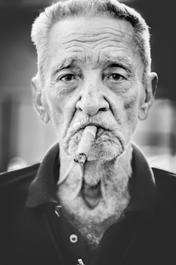 portrait photography,how to photograph cigar; grayscale photography of man smoking cigar