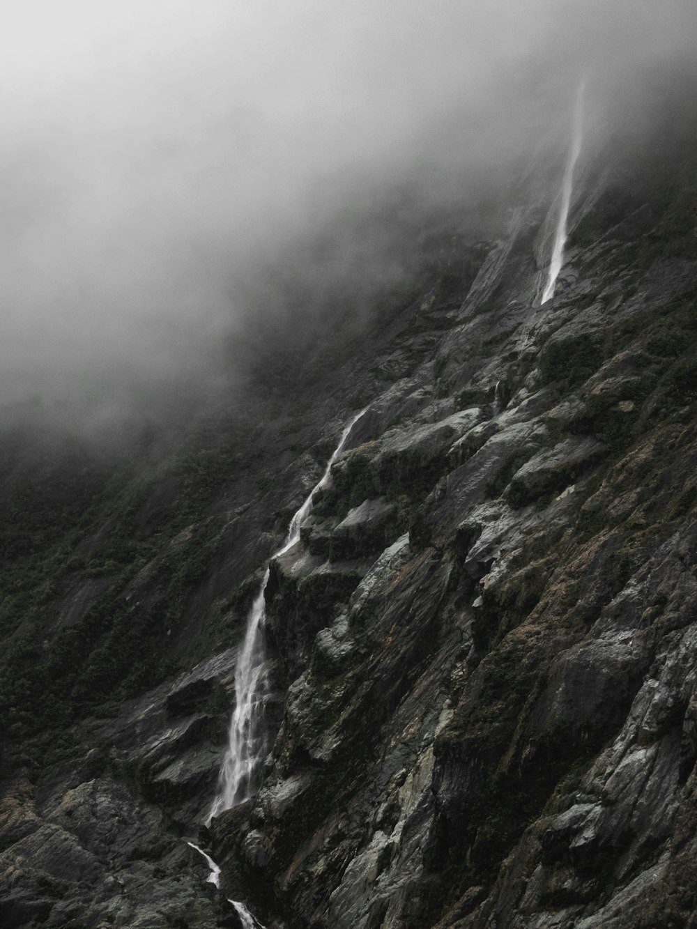 grayscale high-angle photography of rock slope