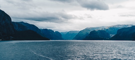 panoramic photo of lake with view of mountains in Lysefjord Norway