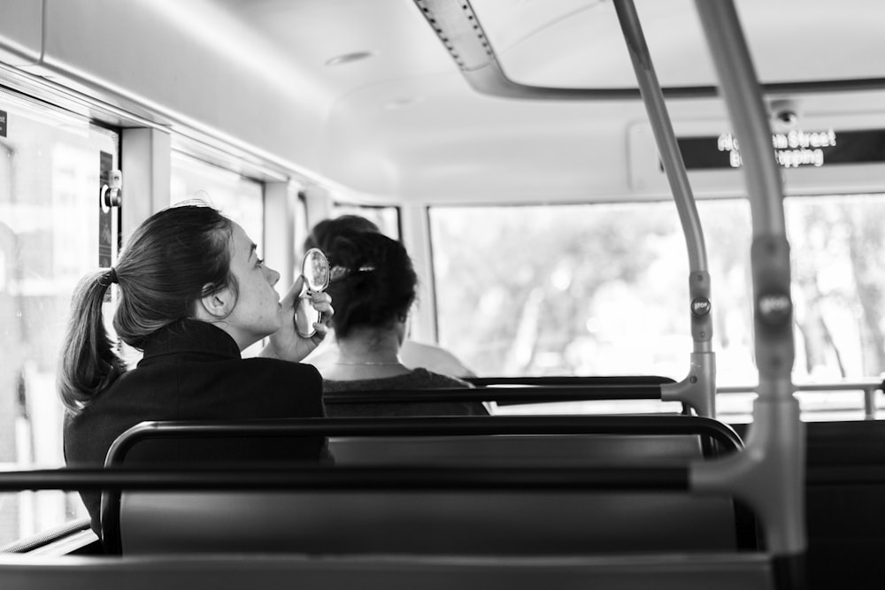 woman sitting on bus bench seat