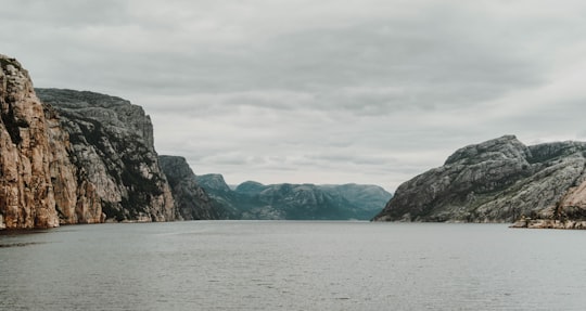 body of water beside brown mountain in Lysefjord Norway