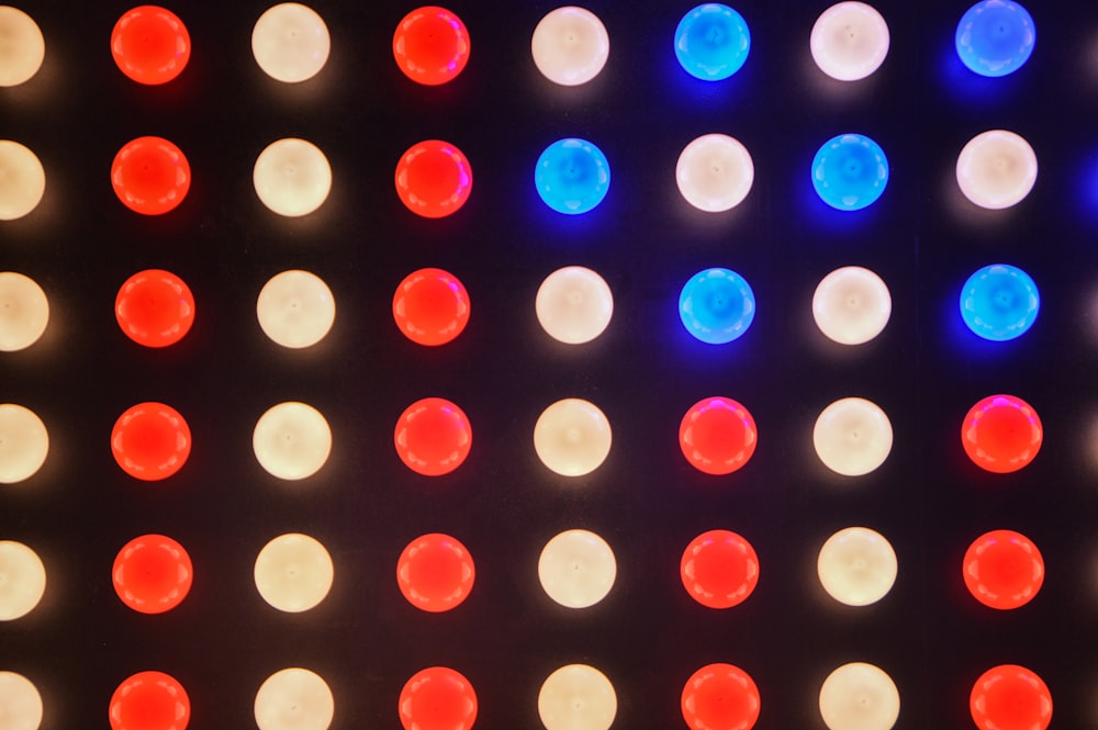 a close up of a wall with many different colored lights