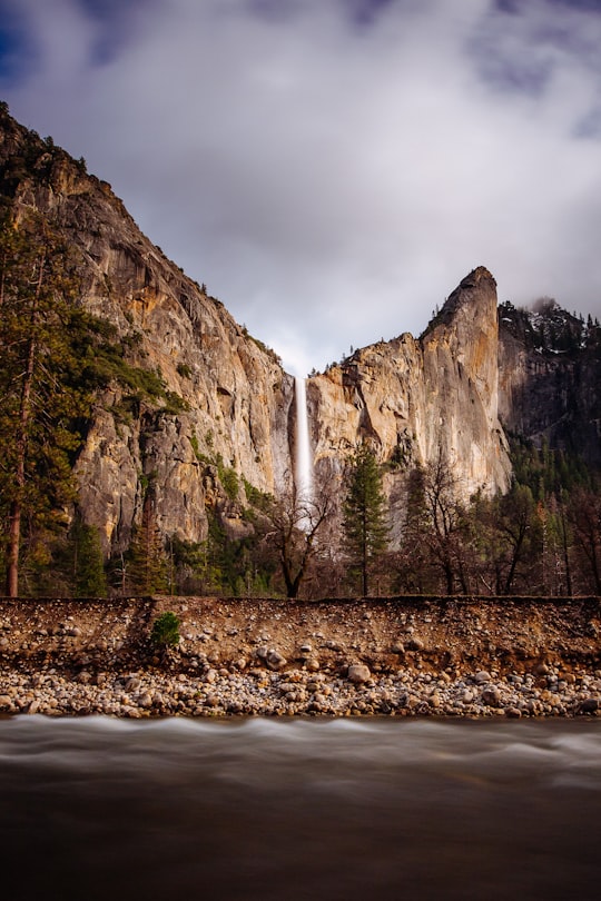 water falls with cloud formation background in Yosemite National Park United States