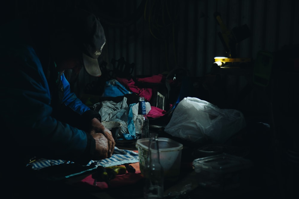 man holding textile on table with lamp