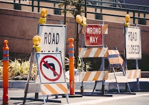 assorted-color signage lot on road during daytime