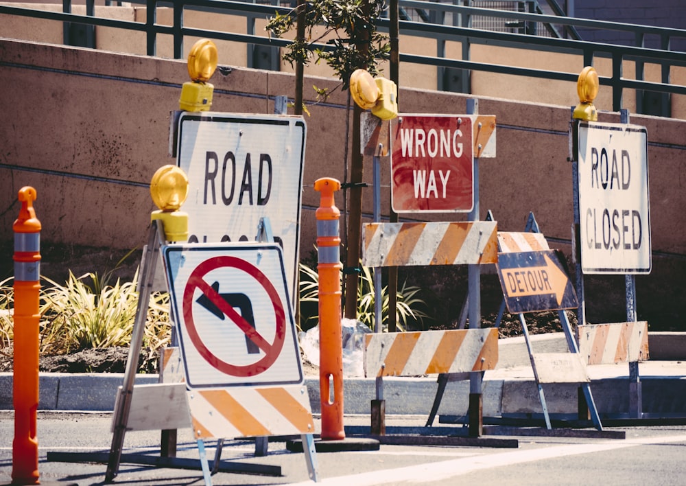 assorted-color signage lot on road during daytime