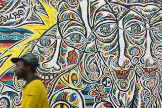 man standing near graffiti art