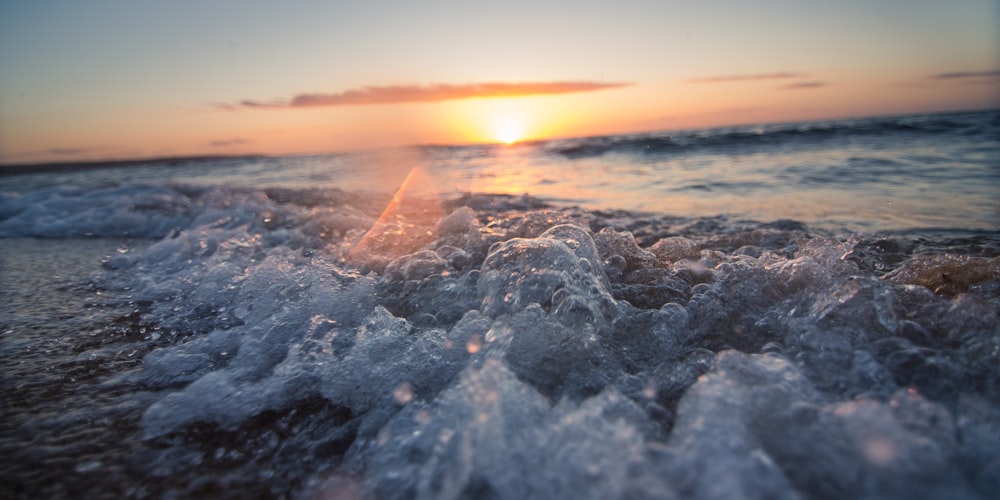 ocean waves by the seashore during sunset