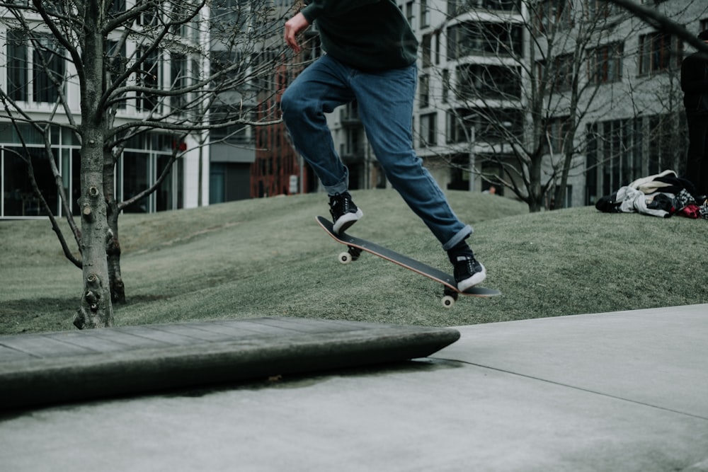 person doing ollie flip kick on skateboard