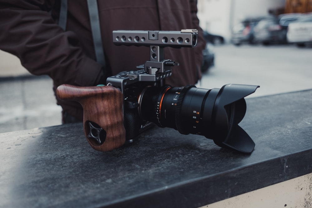 black DSLR camera on top of black table