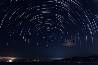a star trail over a body of water