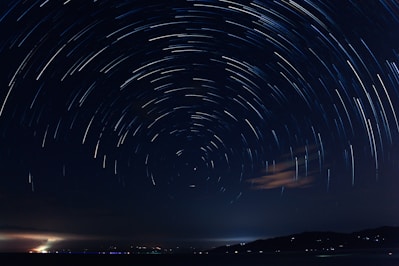 a star trail over a body of water