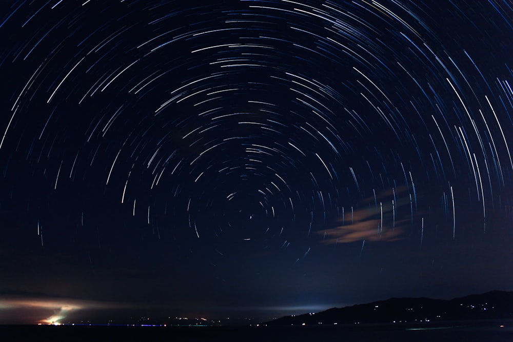 a star trail over a body of water