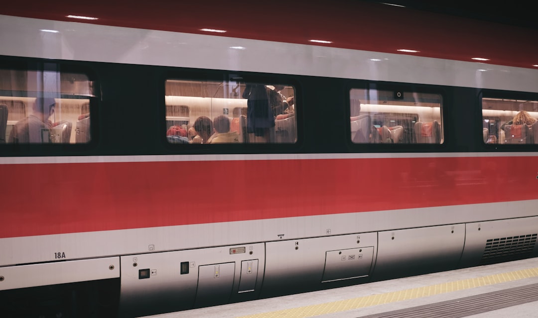 group of people inside red and gray train,
