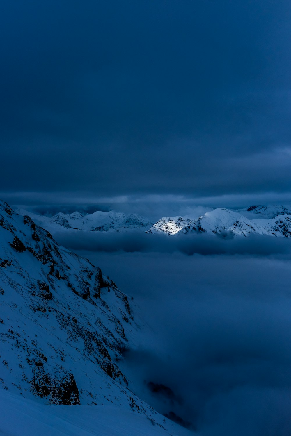 snow capped mountain covered in clouds