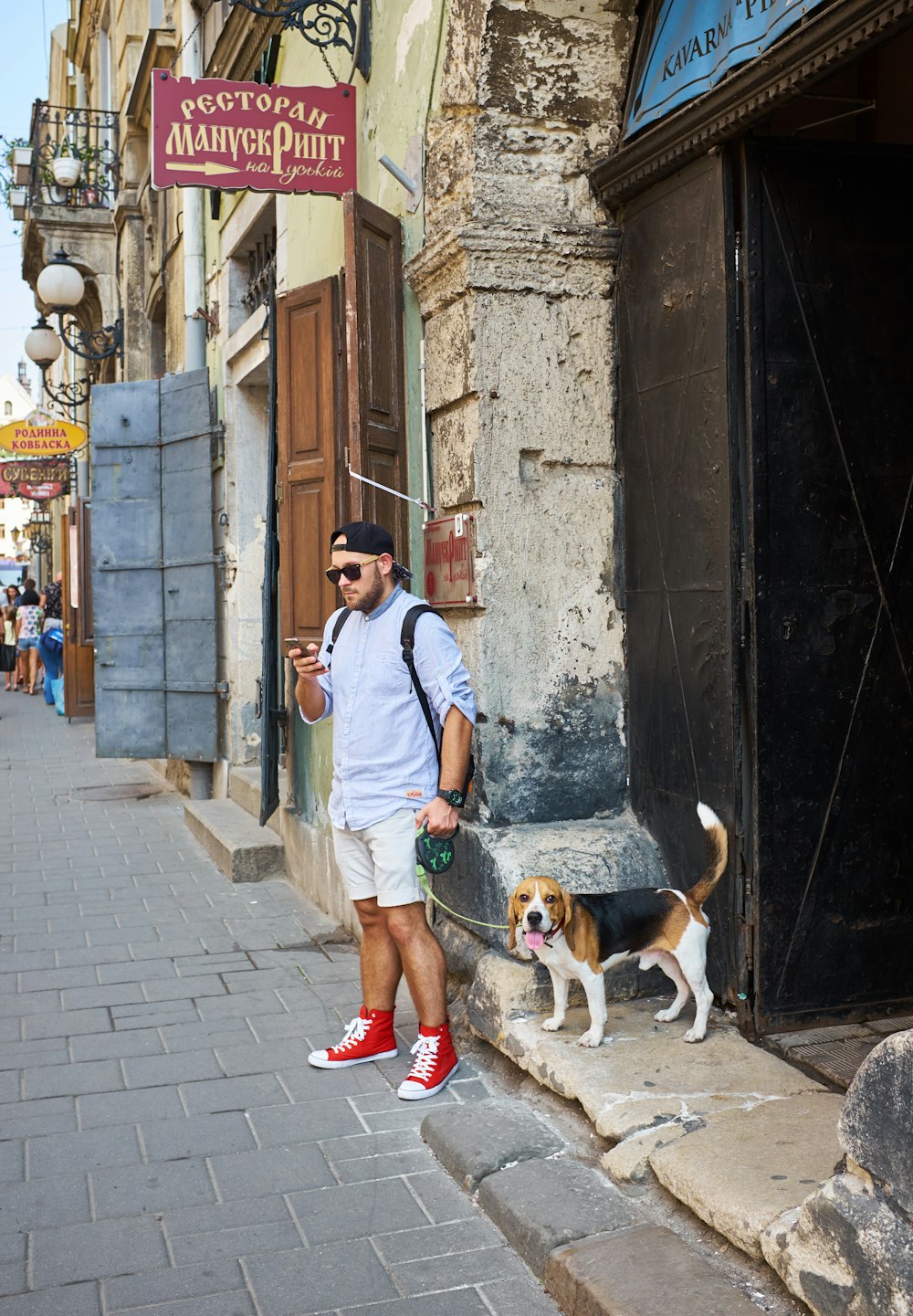 man beside beagle near building structure