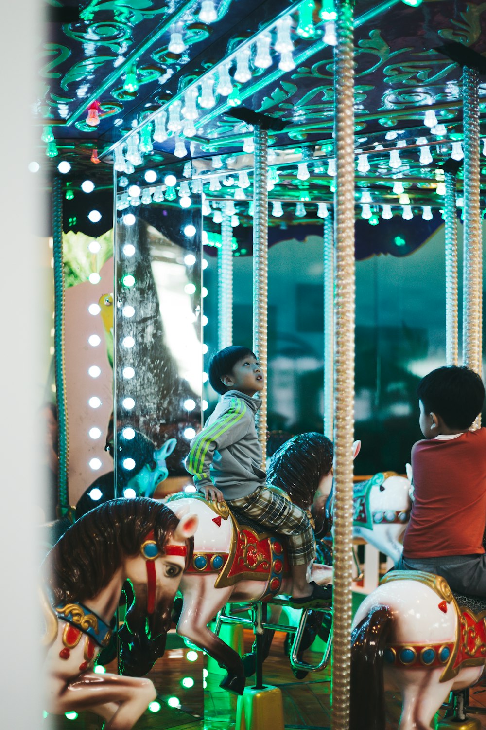 boy riding on carousel