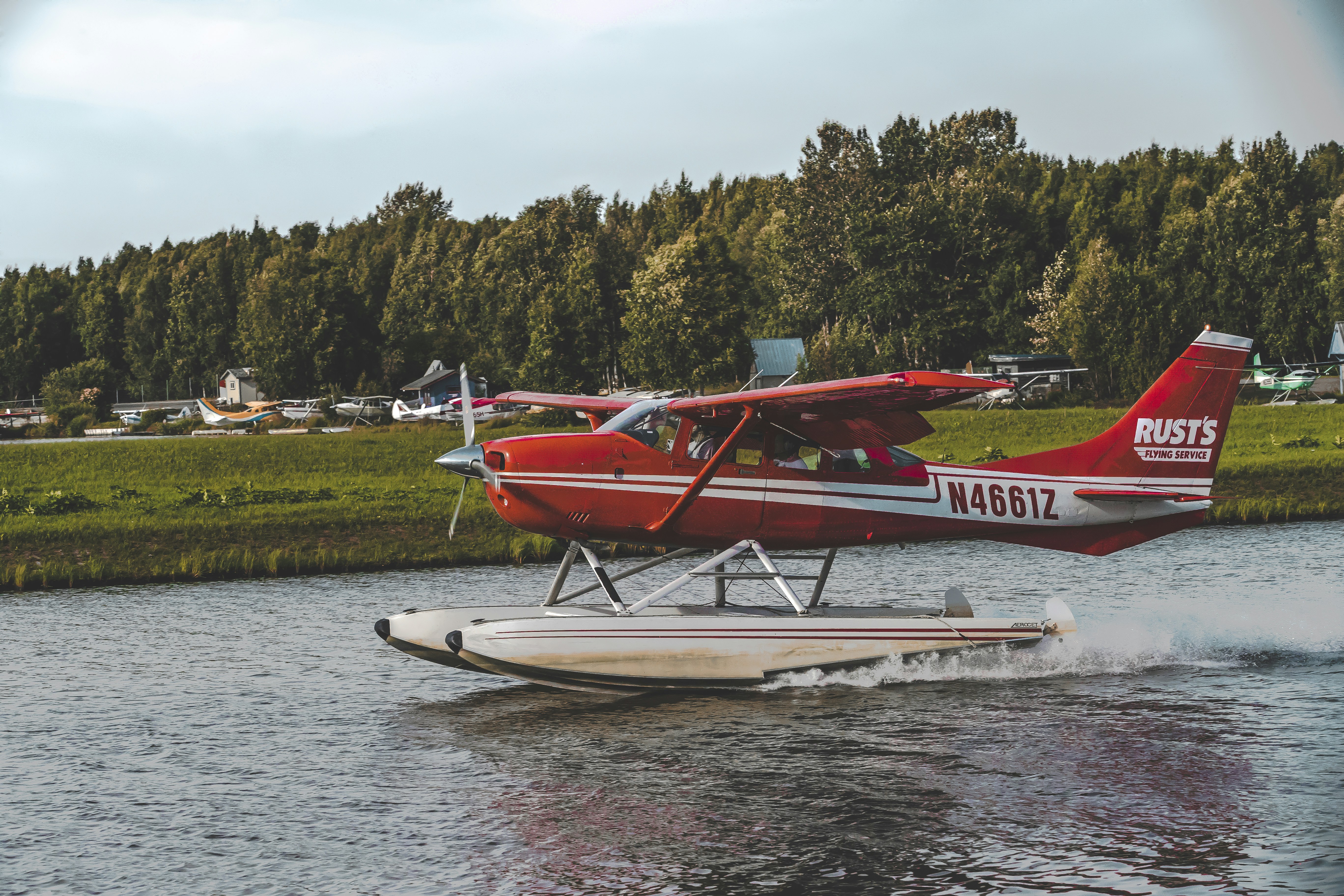 red and white Rusts N46612 biplane on body of water, Come Fly With Me