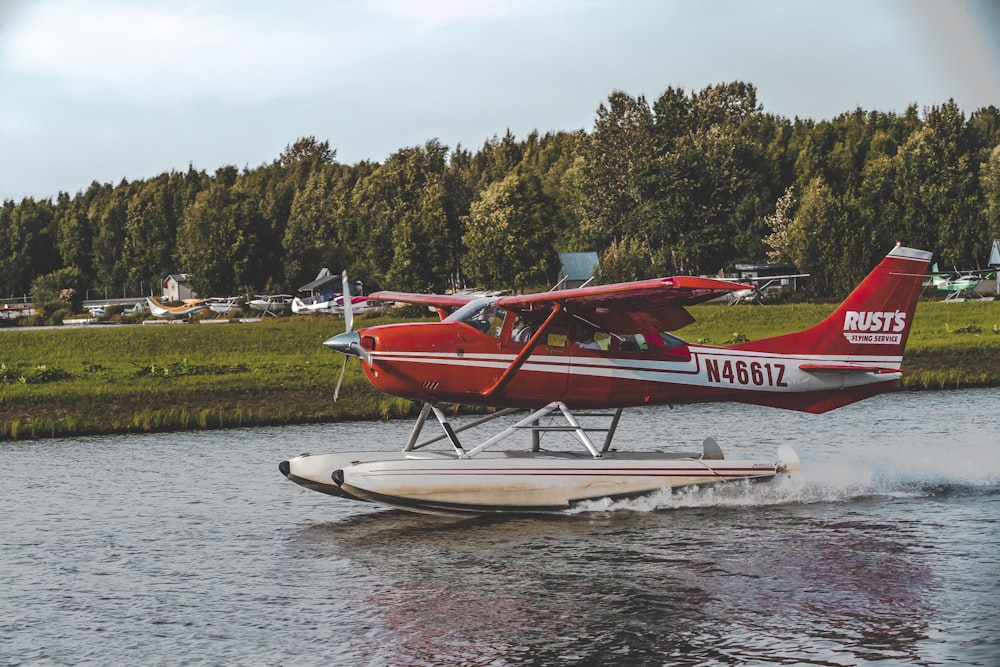 red and white Rusts N46612 biplane on body of water