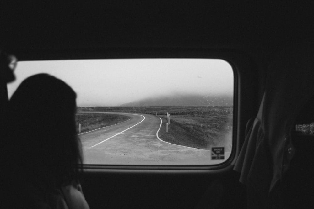 woman looking outside automotive window