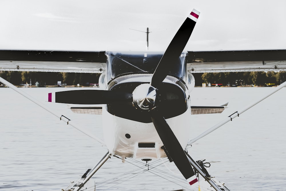 white and black propeller plane