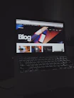 A sleek laptop displaying an AI-powered blog interface with vibrant tech graphics.