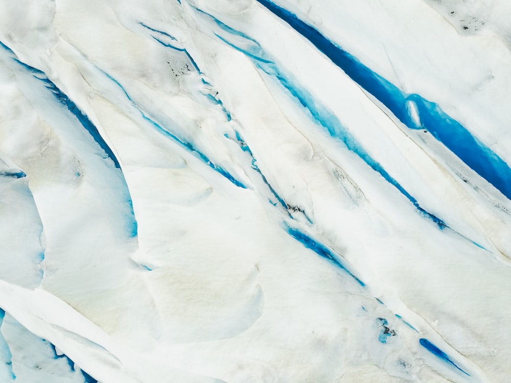an aerial view of a blue and white glacier