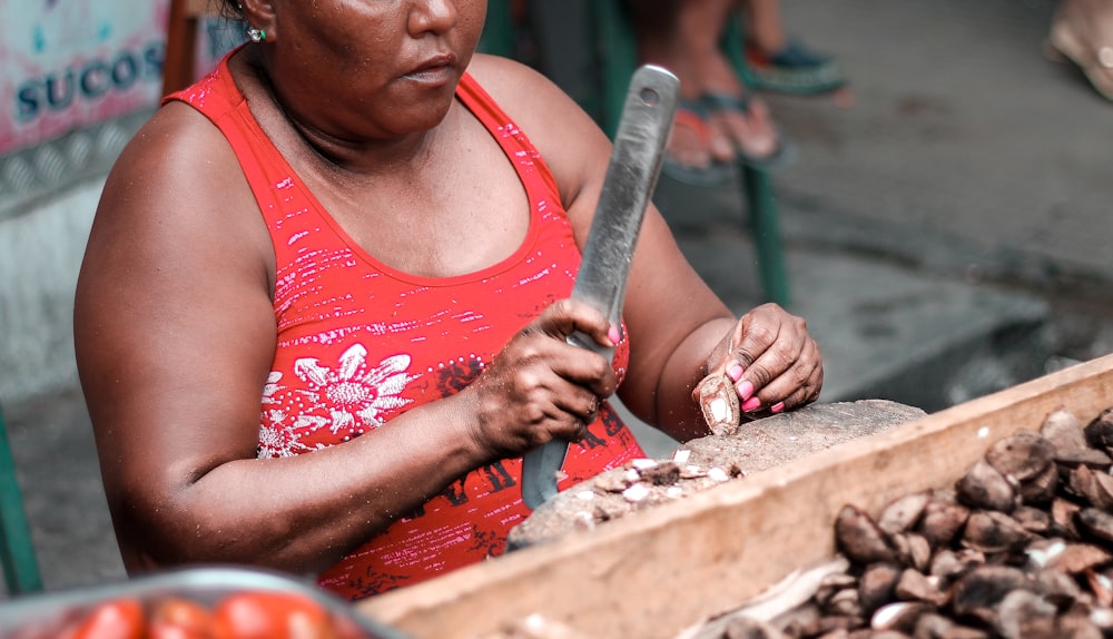 a woman holding a large knife in her hands