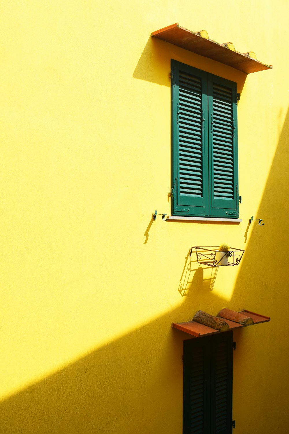 green wooden window under brown awning