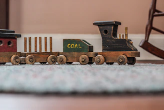 beige wooden toy train selective focal photo