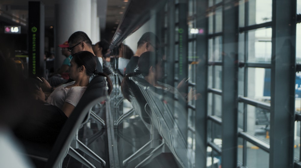 people sitting on gang chair at daytime