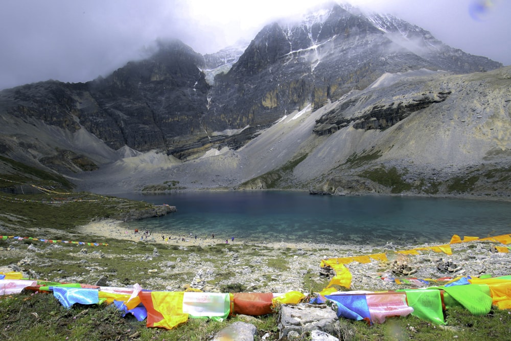 large body of water near mountain during daytime